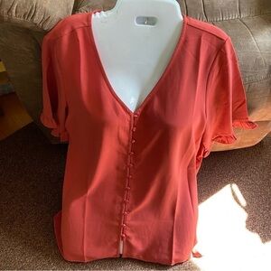 Terra cotta blouse w/ ruffle sleeves. Button down, feminine business attire.